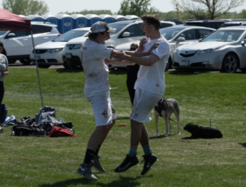Mats Hansen, junior, celebrates after scoring a point with AJ Condon, senior in the championship game against Fox Valley Fusion in the Hopkins Hustle Tournament. HURT won 12-9.