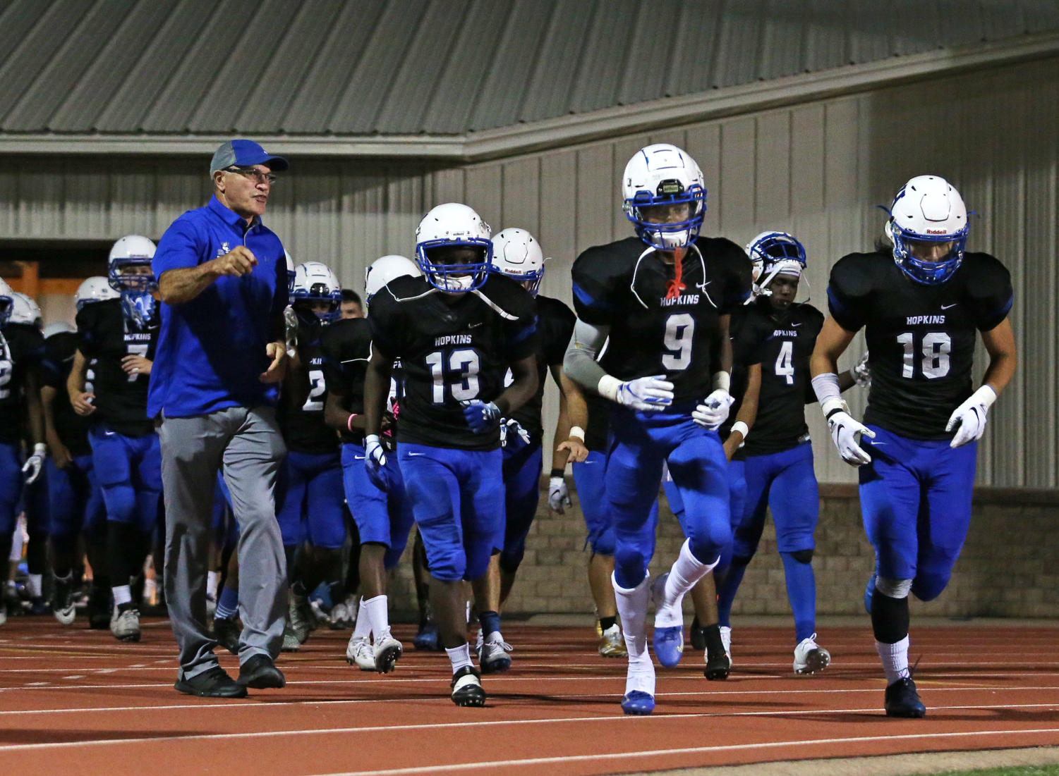 The Royals football team runs out of the locker room during a game this season. The Royals take on Spring Lake Park this season.