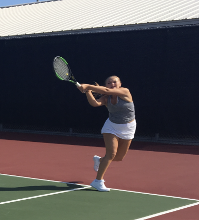 Mary Murphy, junior, returns a backhand. Murphy is a part of the Girls varsity tennis team.