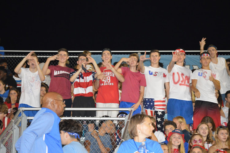 The Sam Segelbaum fan section poses for a picture at an HHS football game. Their creative chants were yelled all season long.