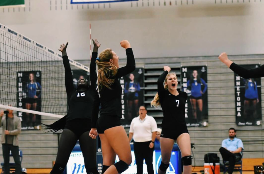 Anna Erickson, senior, celebrates a point with her team. Erickson is committed to Central Michigan?