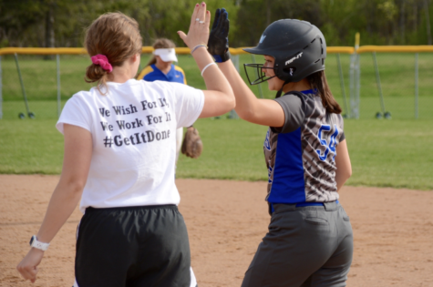 Annika Crouser, junior, talking with coach. Crouser plays second base.