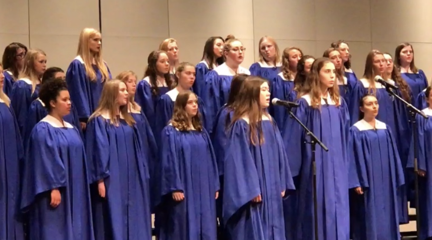 HHS+choir+and+Troutman+singing+at+a+concert.