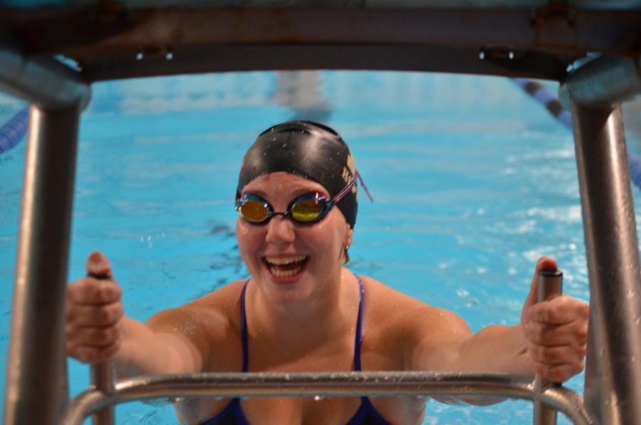 Ali Hall, senior, climbs out of the pool after a race. Hall, recently committed to SDSU.