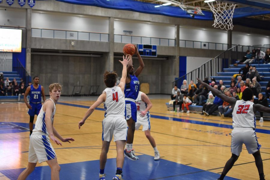 Cornell Richardson, senior, shoots the ball over and Armstrong player. Richardson and the Royals won this game 79-56.