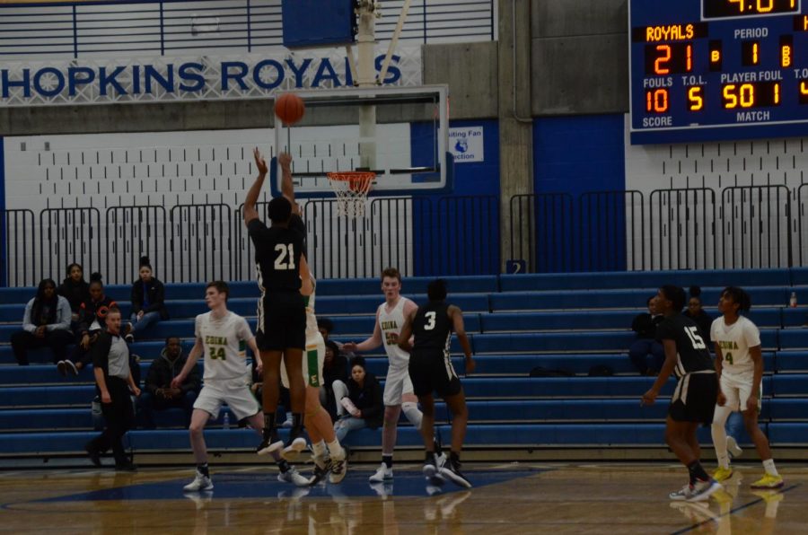 Andre Gray, junior, attempts a three pointer in a game against Edina. Gray and the Royals are currently ranked fifth in state.