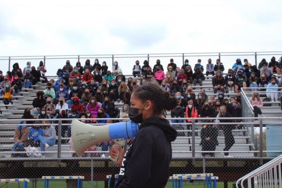 A North Junior High student holds the megaphone while speaking to hundreds of HHS and fellow NJH students. 