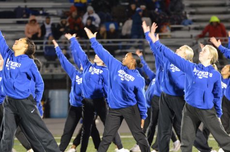The Royals Dance Crew shines as they perform during halftime at the homecoming football game.